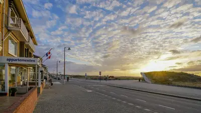 a street with a building on the side of a road at Appartementen Zeezicht - 1 in Katwijk aan Zee
