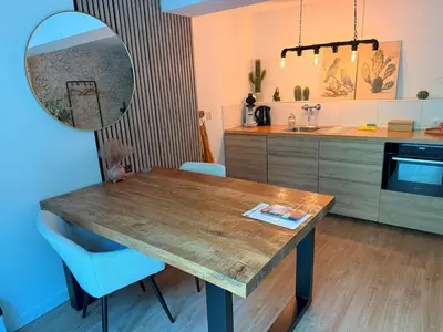 a kitchen with a wooden table and a mirror at Garden Room or Economy Room in Amsterdam