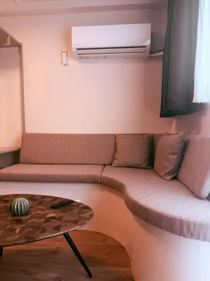 a living room with a couch and a table at Garden Room or Economy Room in Amsterdam