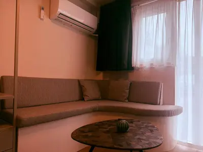 a living room with a couch and a table at Garden Room or Economy Room in Amsterdam
