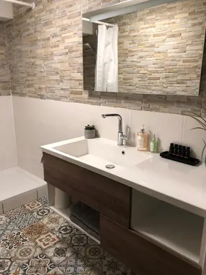 a bathroom with a sink and a mirror at Garden Room or Economy Room in Amsterdam