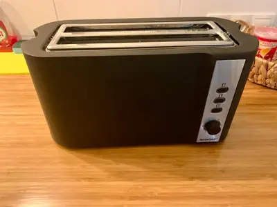 a black toaster oven sitting on a wooden floor at Garden Room or Economy Room in Amsterdam