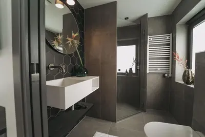 a bathroom with a white sink and a mirror at Hotel Bell in Zandvoort
