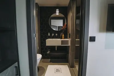 a bathroom with a sink and a mirror at Hotel Bell in Zandvoort