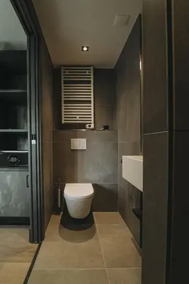 a bathroom with a toilet and a sink at Hotel Bell in Zandvoort