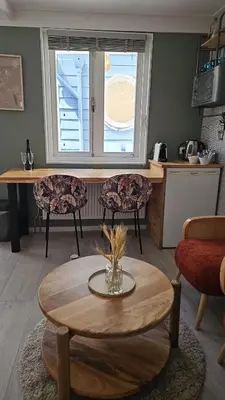 a living room with a table and chairs and a window at Villa Hop Zandvoort in Zandvoort