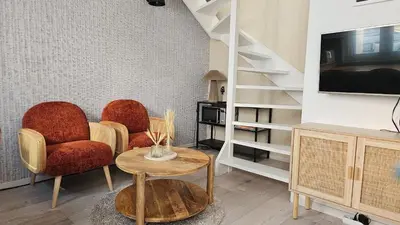 a living room with two chairs and a table at Villa Hop Zandvoort in Zandvoort