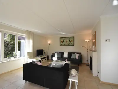 a living room with a couch and a table at Family Home in Zeewolde by Forest Trails in Zeewolde
