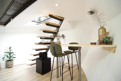 a staircase in a room with a table and stools at Eco HouseBoat in Amsterdam