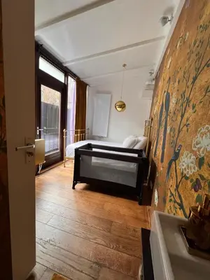 a bedroom with a bed and a sink in a room at BEAUTIFUL APARTMENT WiTH ASIAN STYLE BEDROOM NEAR RAI & CENTER in Amsterdam