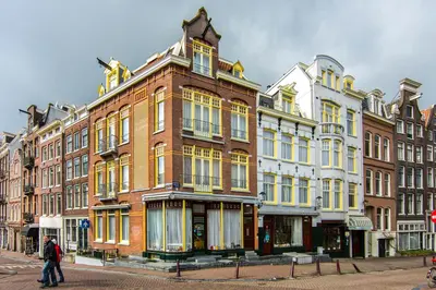 a large brick building on the corner of a street at Amsterdam Wiechmann Hotel in Amsterdam