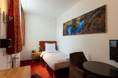 a hotel room with a bed and a tv at Amsterdam Wiechmann Hotel in Amsterdam