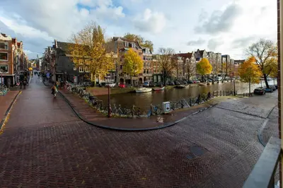 a city street with a river and buildings at Amsterdam Wiechmann Hotel in Amsterdam