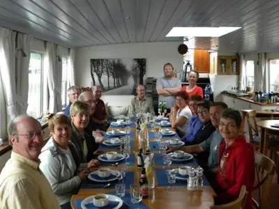 a group of people sitting around a long table at Hotelschip Gandalf in Amsterdam