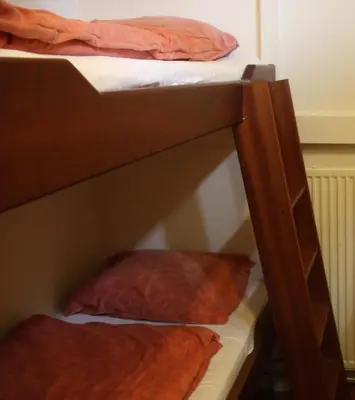 a bunk bed with two pillows on the bottom bunk at Hotelschip Gandalf in Amsterdam