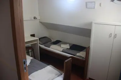 a small room with two bunk beds in it at Hotelschip Gandalf in Amsterdam