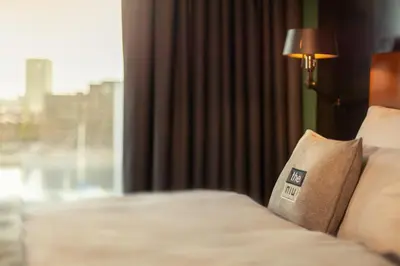 a hotel room with a bed with a pillow on it at Holiday Inn - the niu, Fender Amsterdam in Amsterdam