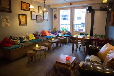 a living room with couches and tables and chairs at Flying Pig Downtown in Amsterdam