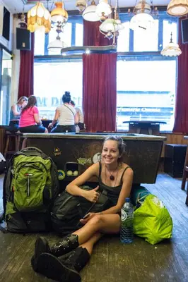 a woman sitting on the floor with her luggage at Flying Pig Downtown in Amsterdam