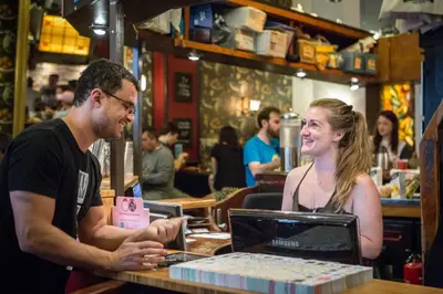 a man and a woman sitting at a table with a laptop at Flying Pig Downtown in Amsterdam
