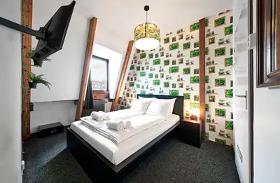 a bedroom with a bed and a wall of pictures at Flying Pig Downtown in Amsterdam