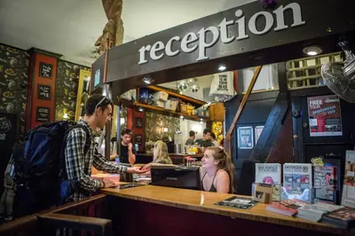 a man standing at a counter in a restaurant at Flying Pig Downtown in Amsterdam