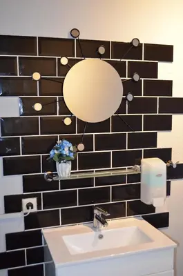 a bathroom with a sink and a mirror on a wall at Flying Pig Uptown in Amsterdam