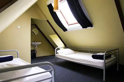 two bunk beds in a room with a window at Flying Pig Uptown in Amsterdam