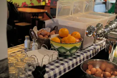 a table with a bowl of oranges and a bowl of eggs at Flying Pig Uptown in Amsterdam