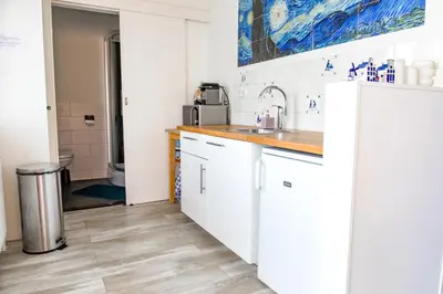 a kitchen with white cabinets and a sink at The New Lake Boathouse in Amsterdam