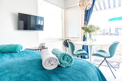 a bedroom with a bed with towels on it at The New Lake Boathouse in Amsterdam