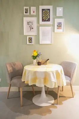 a dining room table with two chairs and a yellow table cloth at NEW! Modern Gallery Nassau Canal Suite in Amsterdam