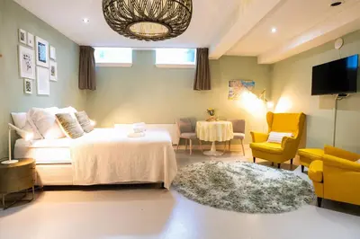a bedroom with a bed and a couch and a table at NEW! Modern Gallery Nassau Canal Suite in Amsterdam