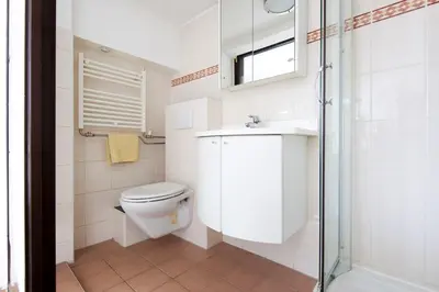 a bathroom with a toilet and a sink and a shower at Zomerhuis Wonders in Zandvoort