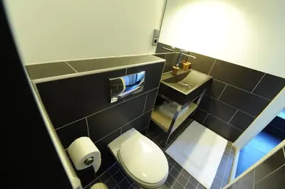 a bathroom with a white toilet and a sink at The Green Tunnel in Amsterdam