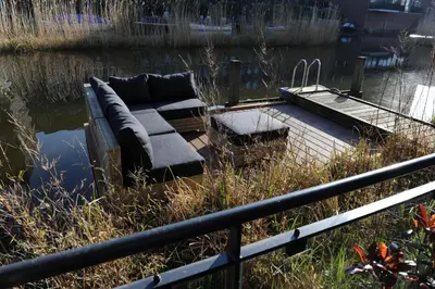 a couch sitting in the middle of a body of water at The Green Tunnel in Amsterdam