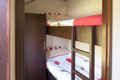 a room with two bunk beds with white sheets at Mariahoeve-Logies #Veenhuisje in Woubrugge