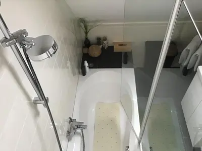 a small bathroom with a shower and a toilet at Sunny dunes in Zandvoort