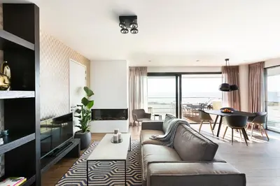 a living room with a couch and a table at Maris Apartments in Egmond aan Zee