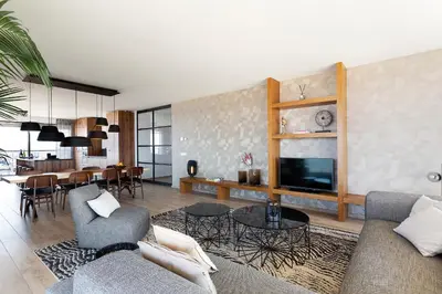 a living room with a couch and a dining room at Maris Apartments in Egmond aan Zee