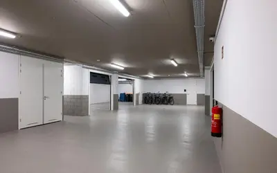 an empty room with white walls and white floors at Maris Apartments in Egmond aan Zee