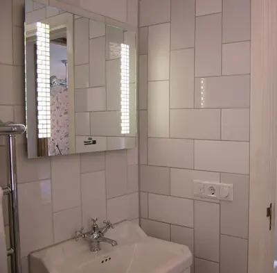a white bathroom with a sink and a mirror at Rosalia's Menagerie Cocktail bar & InnUpstairs in Amsterdam