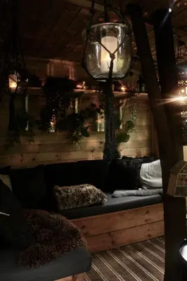 a living room with a couch and a tree at Cavalli's Cottage in Bilthoven