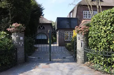an entrance to a house with a wrought iron gate at Cavalli's Cottage in Bilthoven