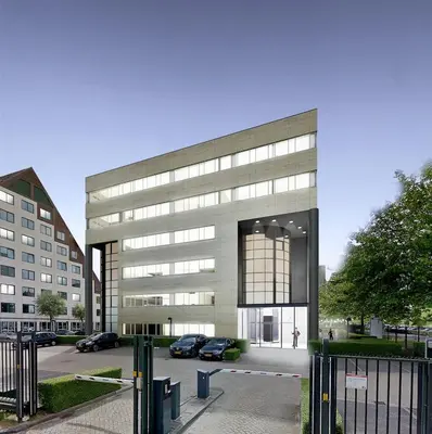 a large building with cars parked in front of it at Via Suites in Amsterdam