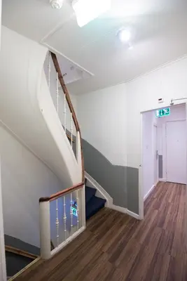 an empty hallway with a staircase in a building at Hotel Amsterdam Inn in Amsterdam