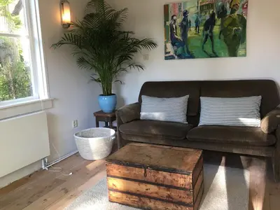 a living room with a couch and a coffee table at Little Constantia in Bergen