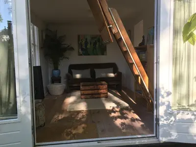 a living room with a couch and a staircase at Little Constantia in Bergen