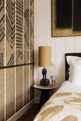 a bedroom with a bed and a lamp on a table at Inn on the Lake in Broek in Waterland