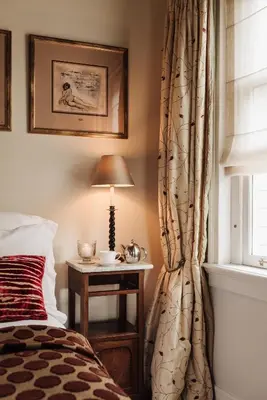 a bedroom with a bed and a table with a lamp at Inn on the Lake in Broek in Waterland